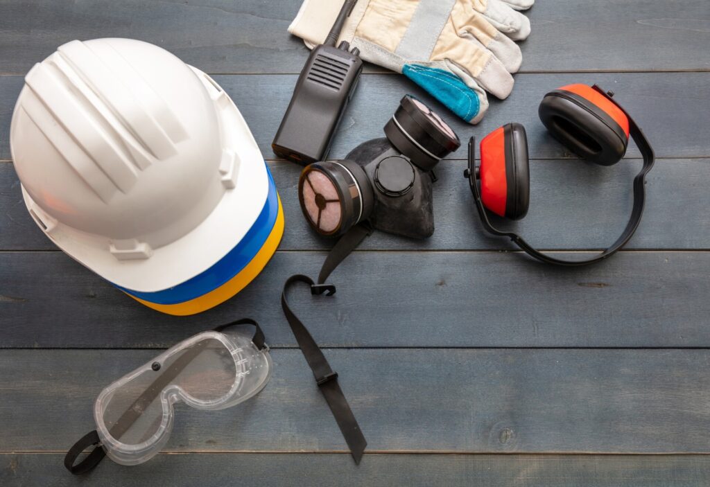 Work safety protection equipment. flat lay on wooden background.